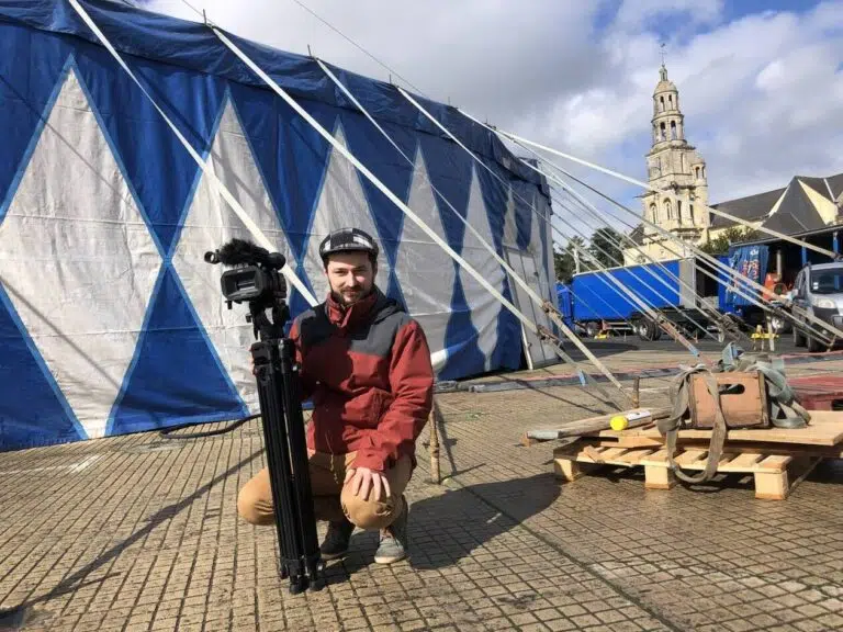 Vidéaste capturant des images devant le chapiteau du Festival International de Cirque de Bayeux 2023